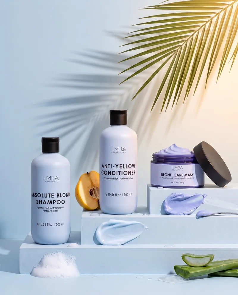 Limba blonde routine: Absolute Blond Shampoo, Anti-Yellow Conditioner and Blond Care Mask on pale blue steps with quince and aloe