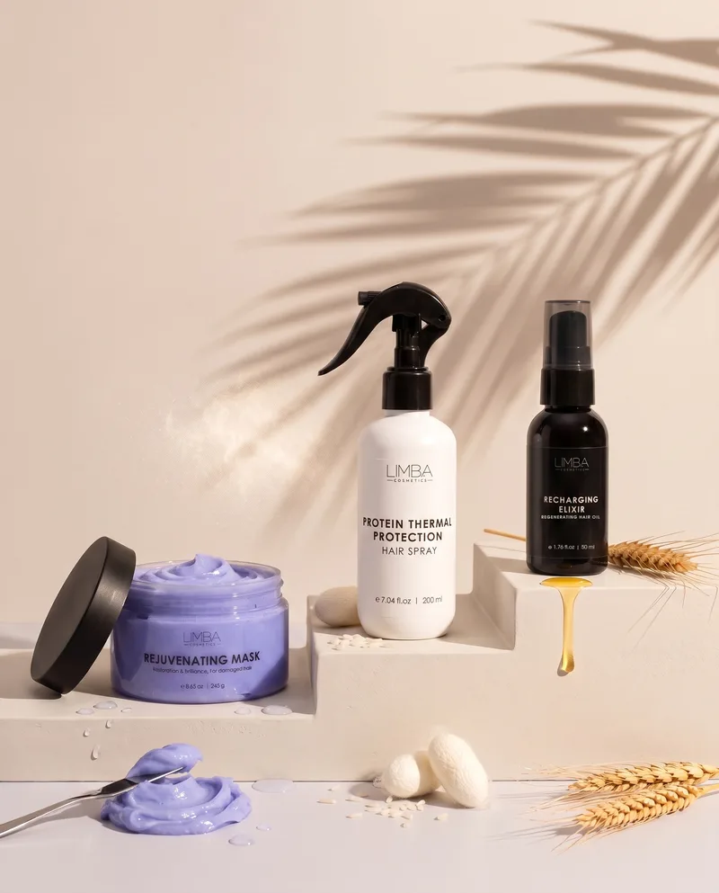 Limba repair routine: Rejuvenating Mask, Protein Thermal Protection spray and Recharging Elixir hair oil on cream steps with silk cocoons, wheat and rice